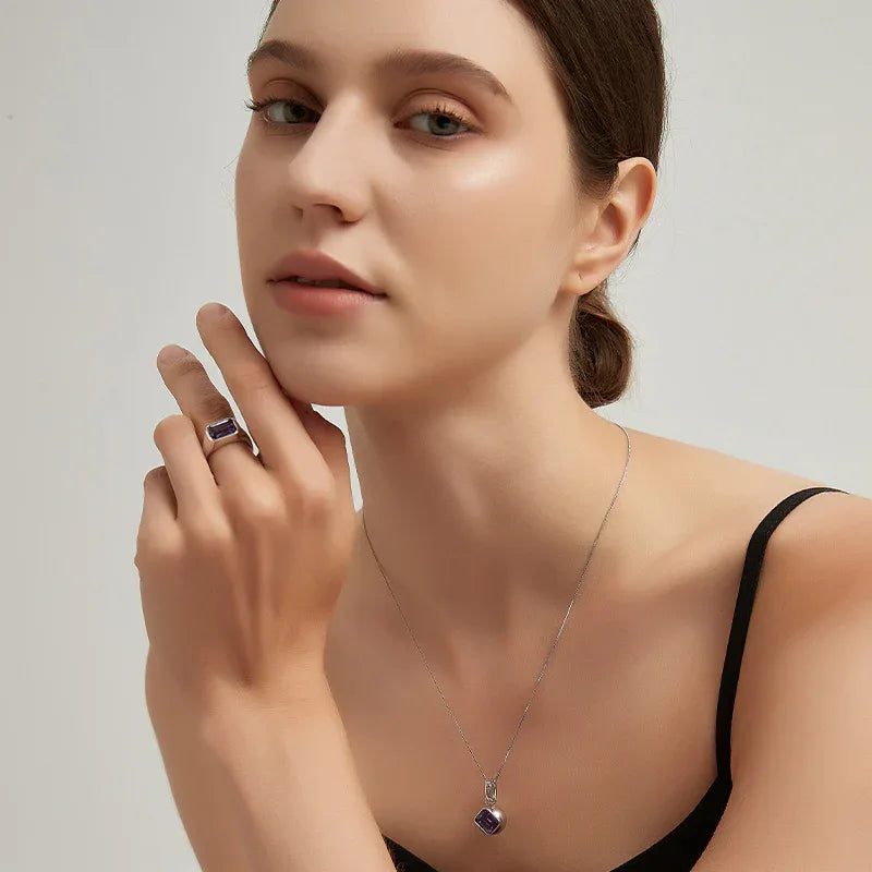 emerald-cut amethyst signet ring worn detail beside the face