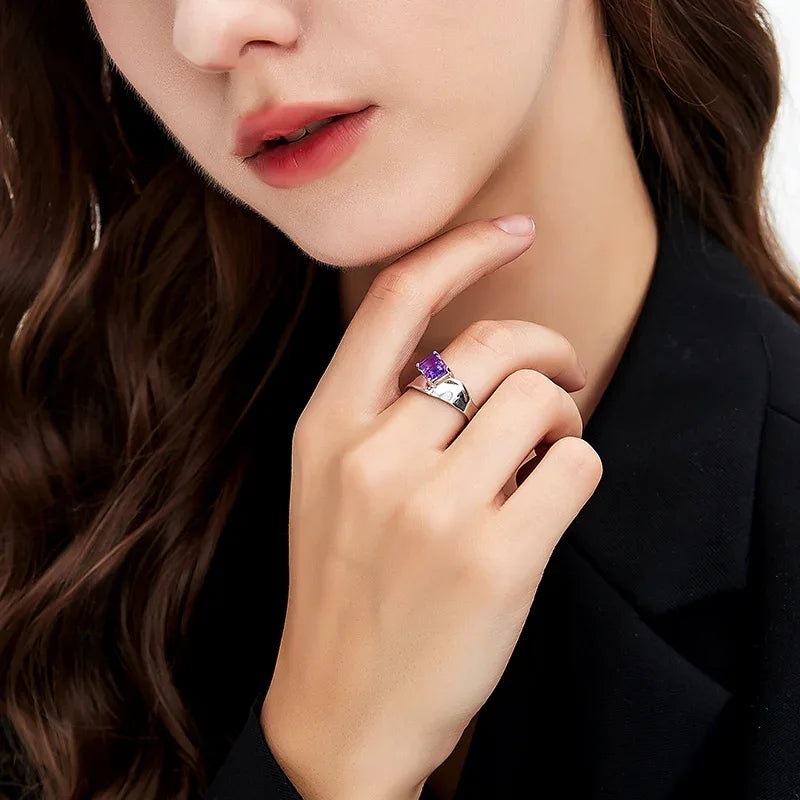 emerald-cut amethyst open ring worn on the hand in a close-up