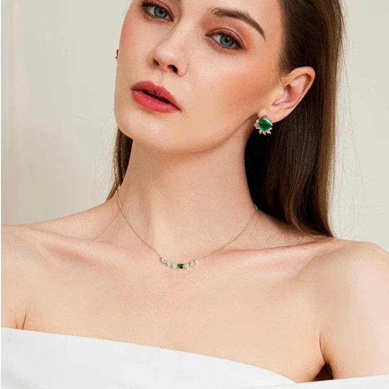 Emerald Leaf Accent Necklace worn at the neckline in a close-up