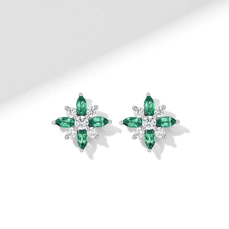 Emerald North Star Stud Earrings paired product view on a dark background