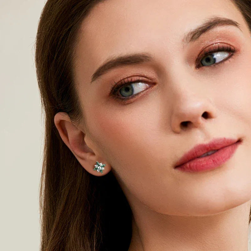 Emerald North Star Stud Earrings worn on the ear in a close-up