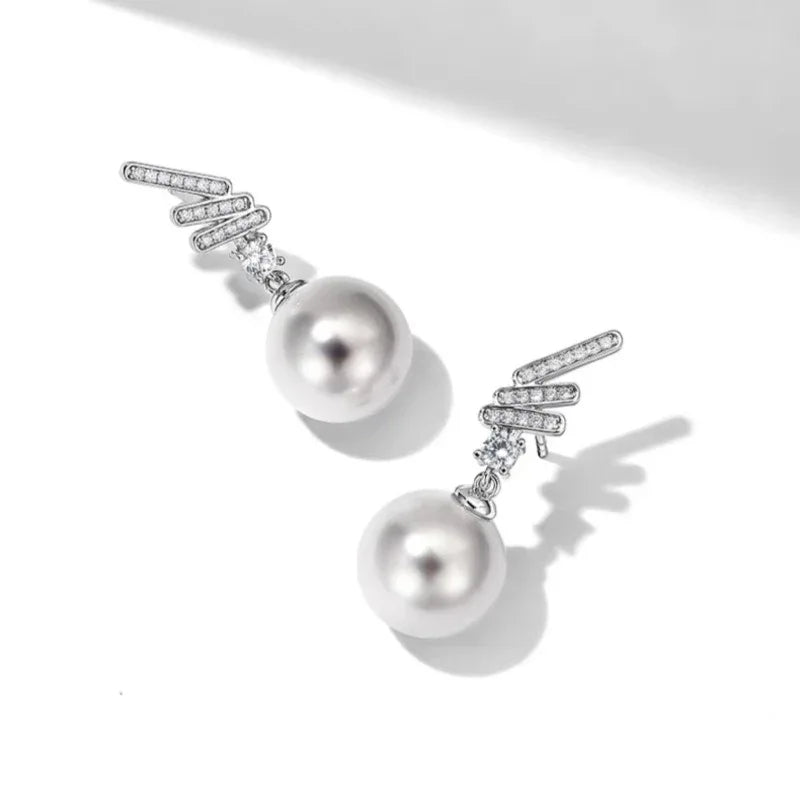 Pearl Wing Drop Earrings — angled pair on white showing the upper wing detail