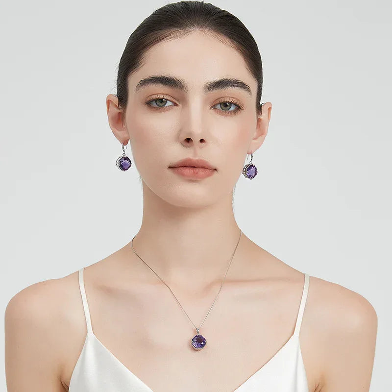 fancy-cut amethyst hook earrings side portrait with the earrings