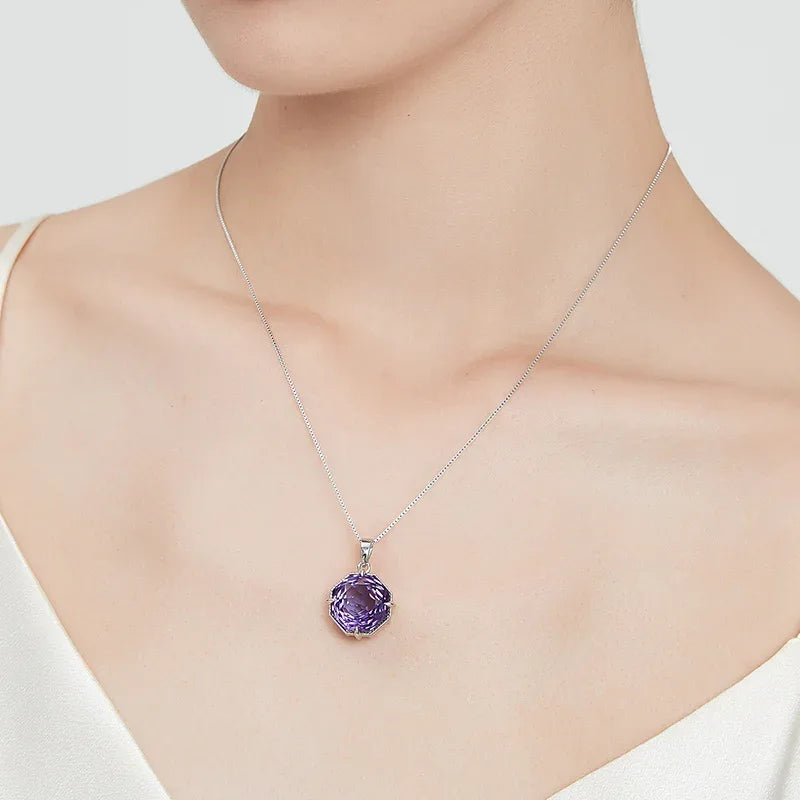 fancy-cut amethyst pendant necklace worn at the neckline in a close-up