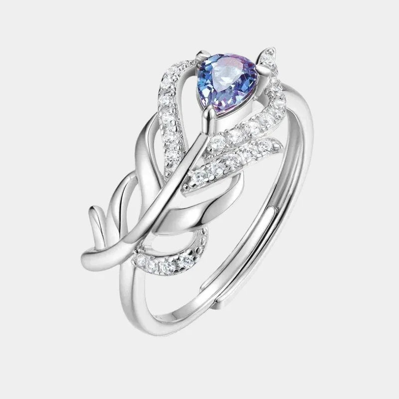 Feather-wrap ring with a Alexandrite and clear accents, front product view on a white background