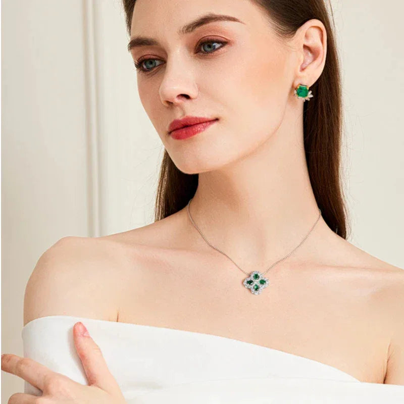 Four-Leaf Emerald Clover Pendant Necklace worn at the neckline in a close-up