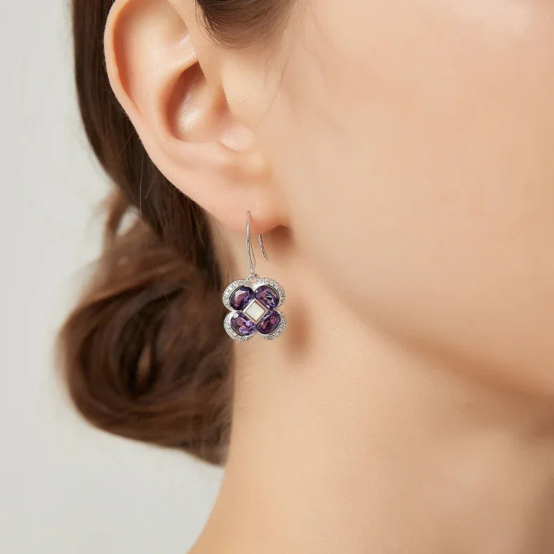 amethyst clover drop earrings worn on the ear from a second angle