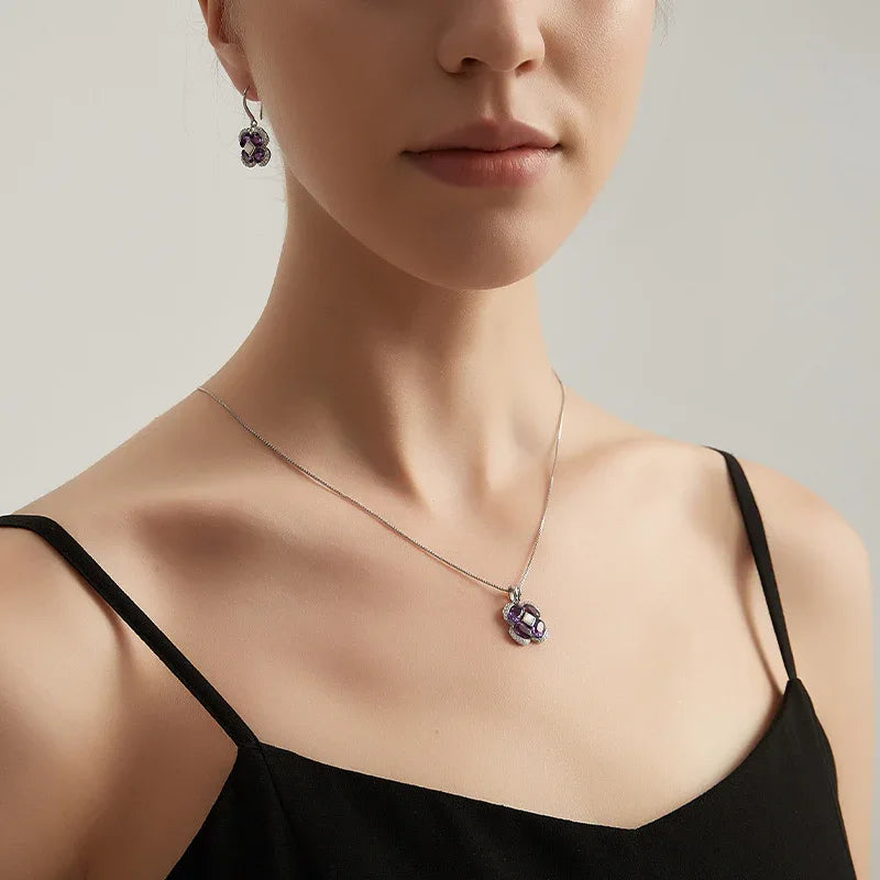 amethyst clover pendant necklace worn at the neckline in a portrait