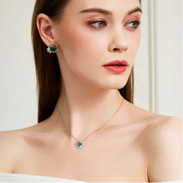 Four-Stone Emerald Floral Pendant Necklace worn at the neckline in a close-up