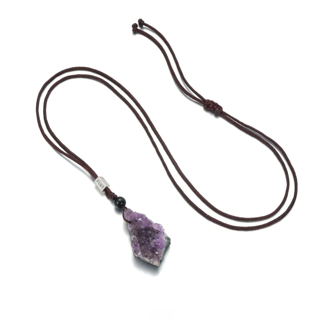 amethyst cluster cord necklace necklace laid flat on a white background