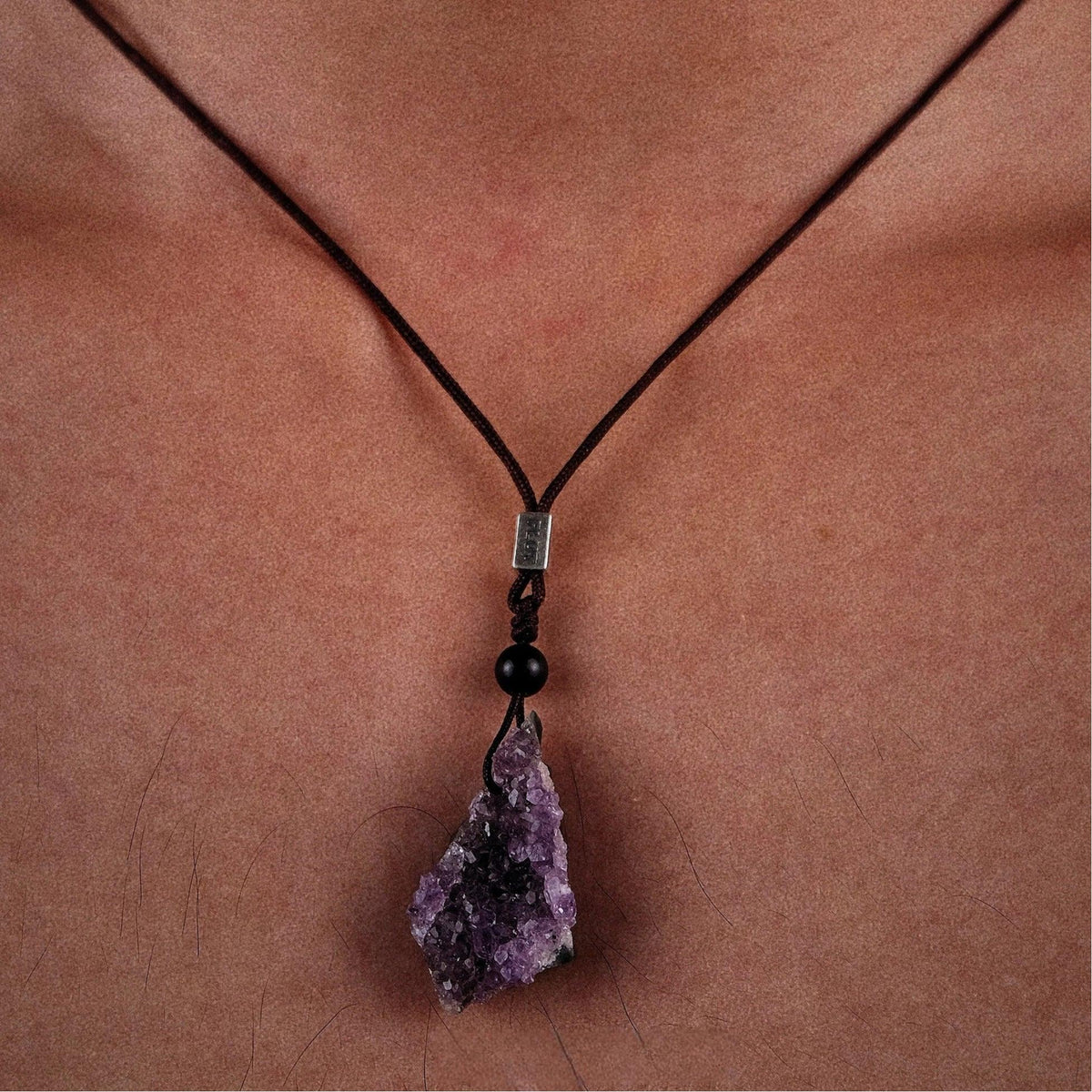 amethyst cluster cord necklace worn at the neckline from the front
