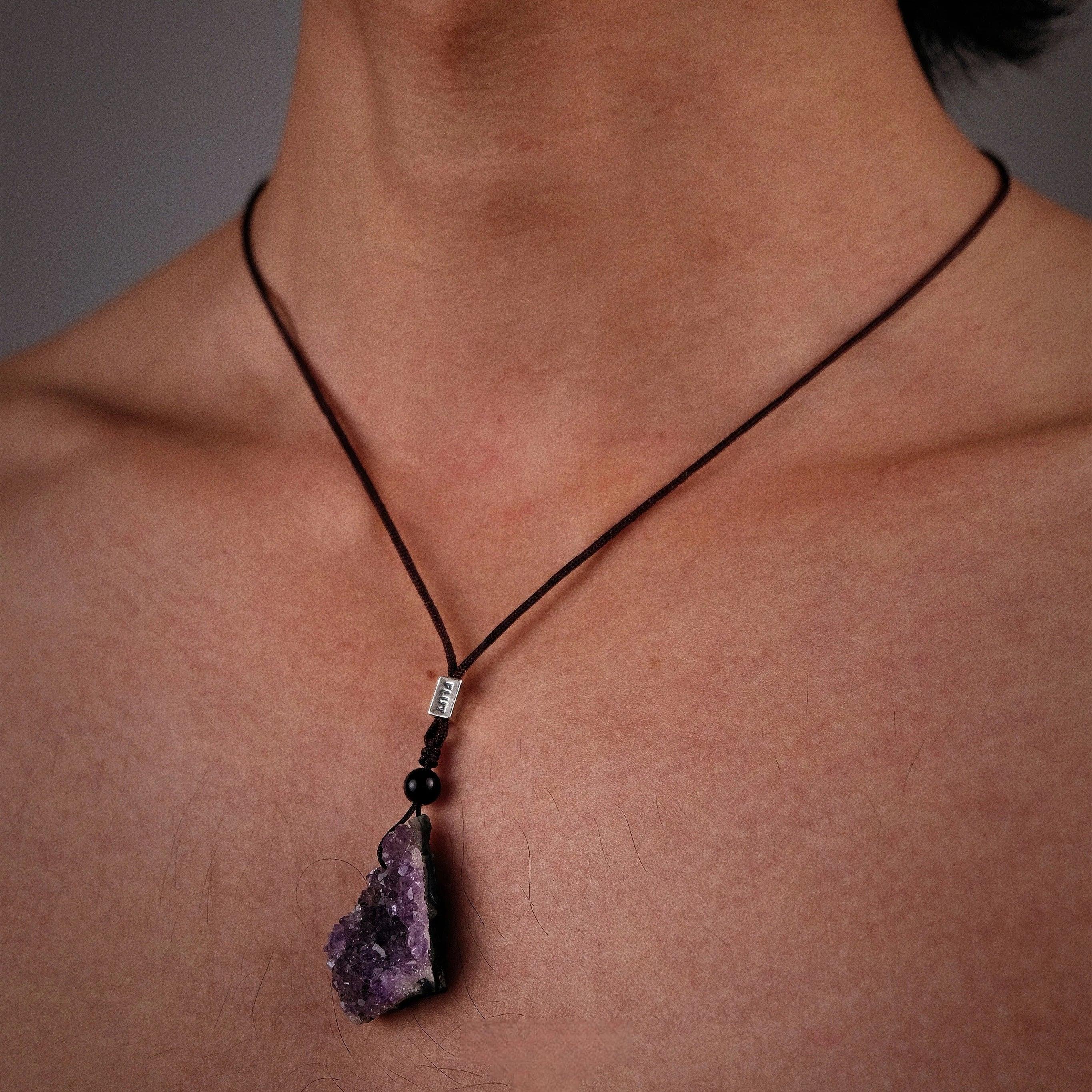 amethyst cluster cord necklace worn at the neckline in a close-up
