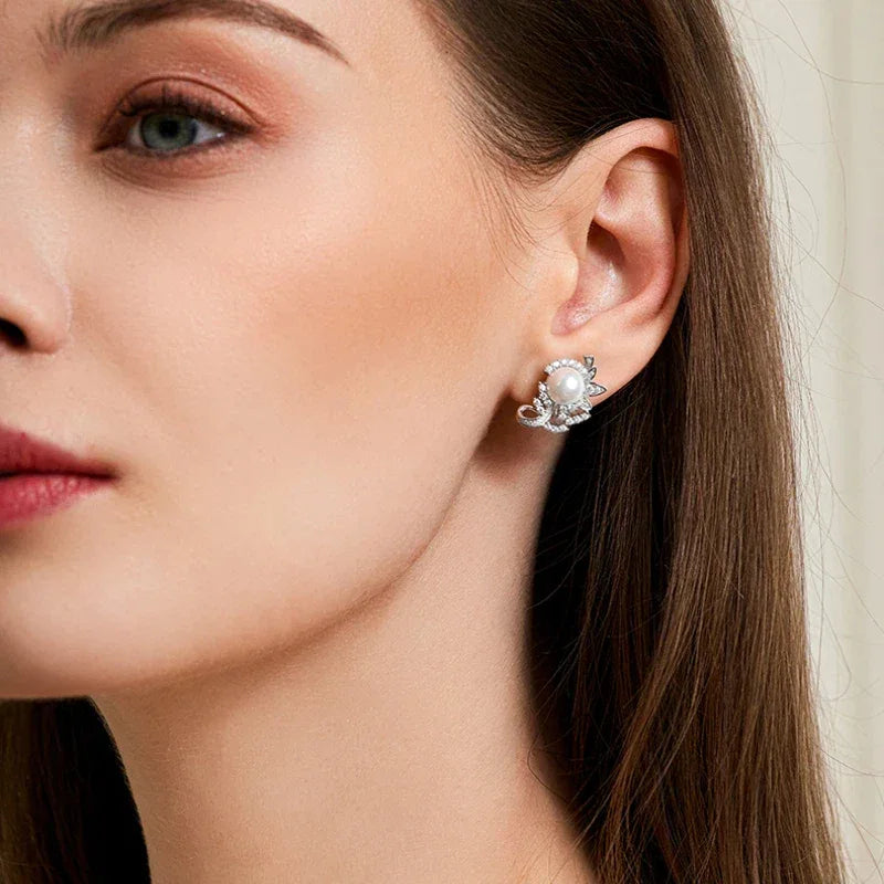 Shell Pearl Floral Cluster Stud Earrings — left-ear worn portrait showing scale
