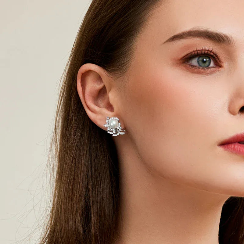 Shell Pearl Floral Cluster Stud Earrings — right-ear worn portrait showing both earrings