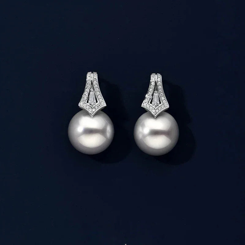 Pearl Drop Earrings with Geometric Fan Detail — pair displayed on a dark background
