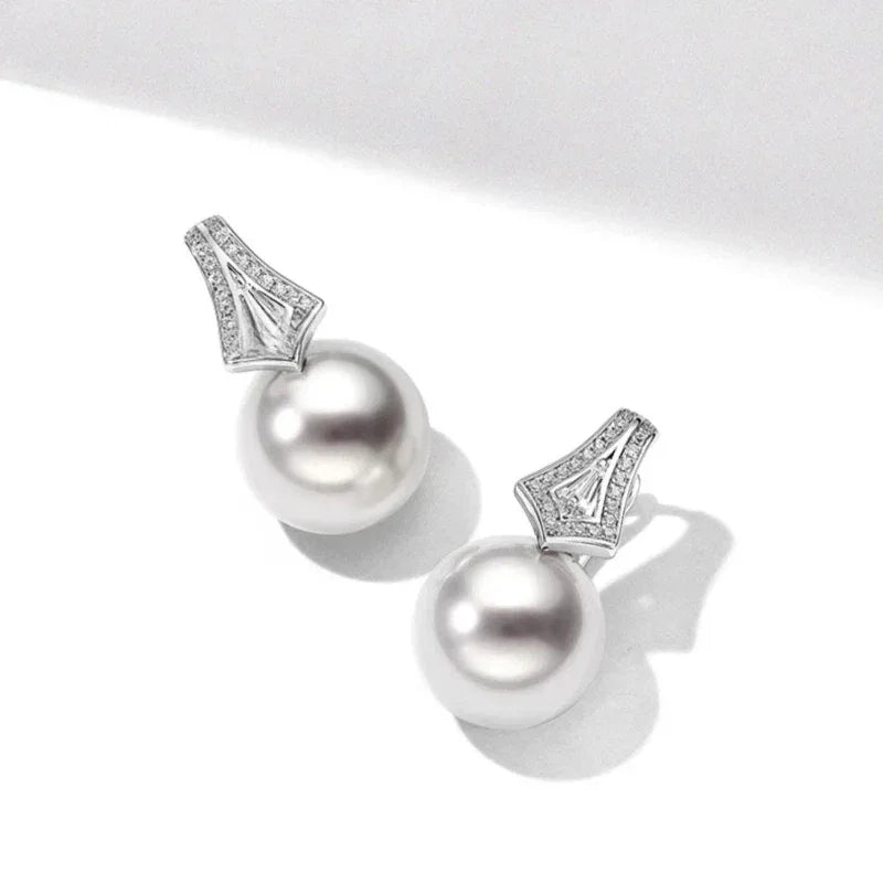 Pearl Drop Earrings with Geometric Fan Detail — angled pair on white showing the post backs