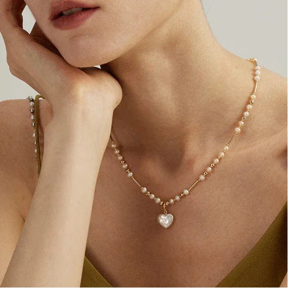Baroque Pearl Heart Pendant Necklace with Gold Bar Accents — side portrait wearing the necklace
