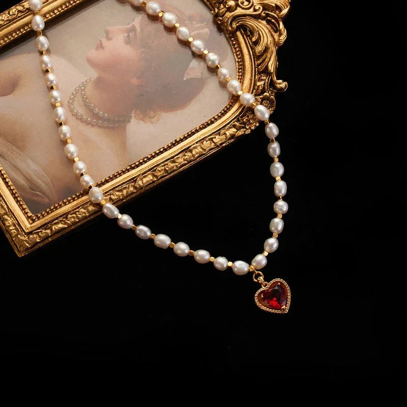 Pearl Strand Necklace with Red Heart Pendant — necklace arranged on a decorative mirror tray