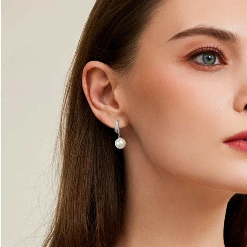 Pearl Tassel Drop Earrings — left-ear worn portrait showing the drop length