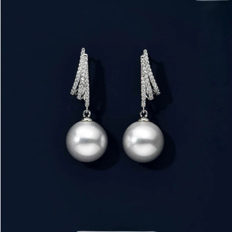 Pearl Tassel Drop Earrings — pair displayed on a dark background