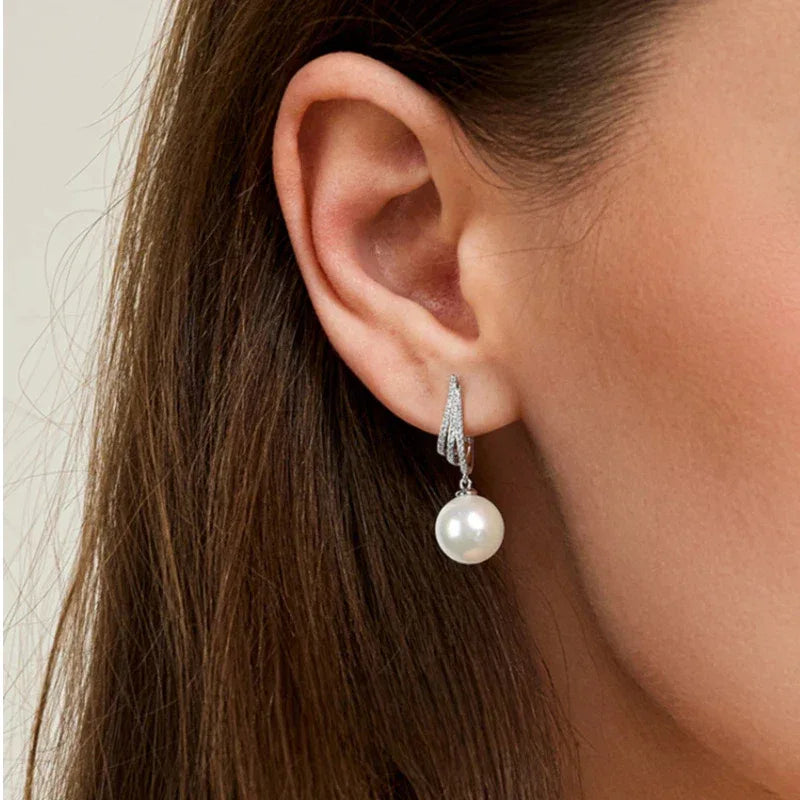 Pearl Tassel Drop Earrings — close right-ear worn view showing scale