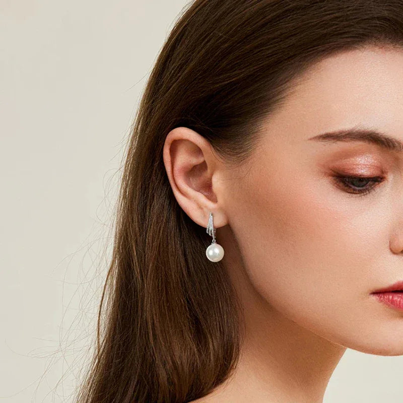 Pearl Tassel Drop Earrings — alternate left-ear worn view with the face angled downward