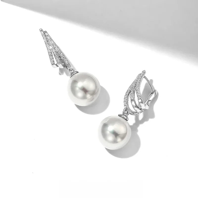 Pearl Tassel Drop Earrings — angled pair on white showing the lever-back fittings