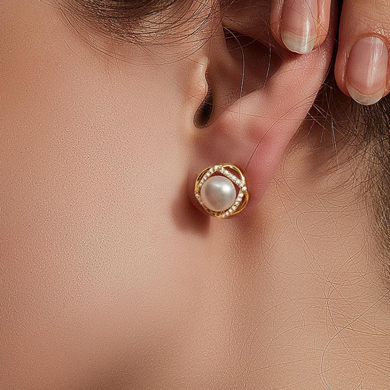 Pearl Halo Stud Earrings — close worn view while a model adjusts the earring