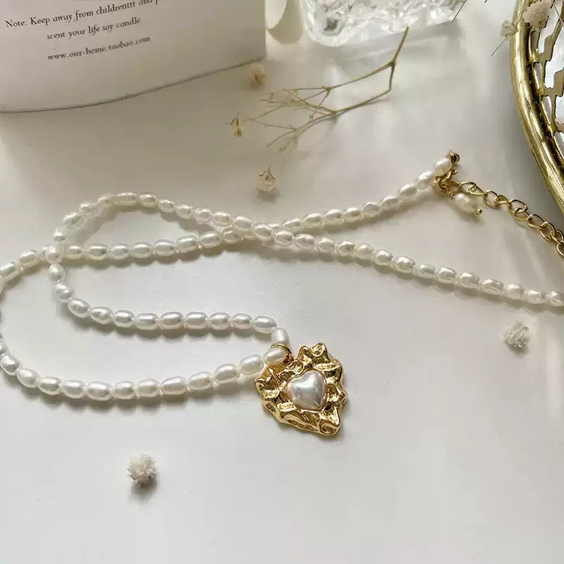 Pearl Heart Pendant Necklace with Gold-Tone Frame — necklace arranged beside a larger pearl strand and other jewelry
