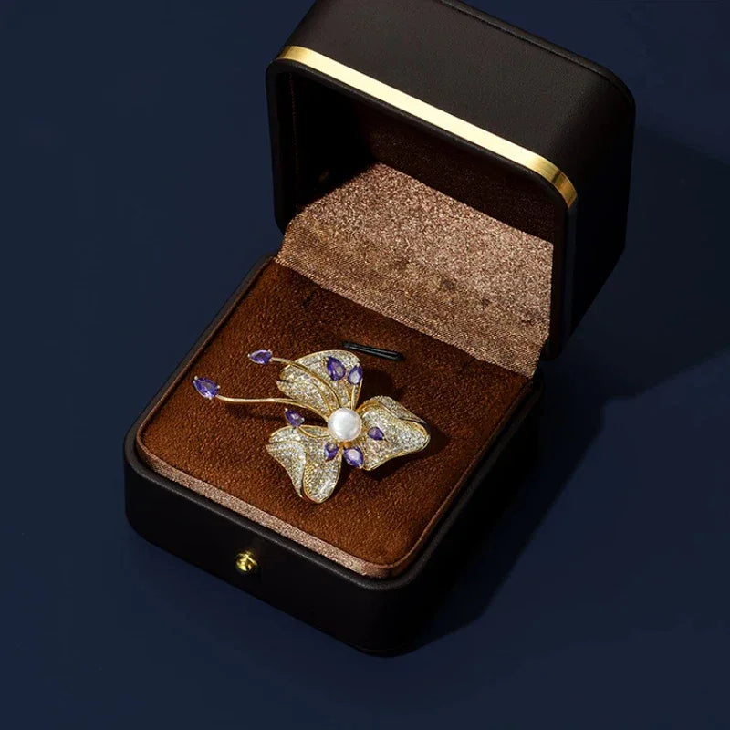 Freshwater Pearl and Cubic Zirconia Bauhinia Brooch — brooch displayed inside a jewelry gift box