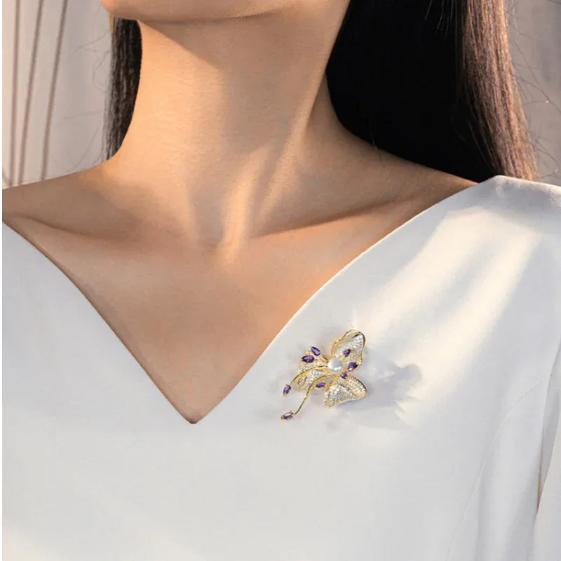 Freshwater Pearl and Cubic Zirconia Bauhinia Brooch — brooch worn on a white blouse