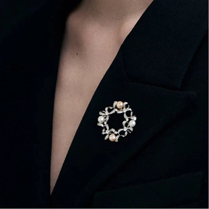 Pearl Bow Wreath Brooch — alternate black-blazer worn view showing design and scale