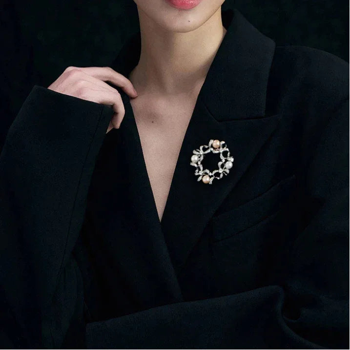 Pearl Bow Wreath Brooch — model portrait with the brooch pinned on a black blazer