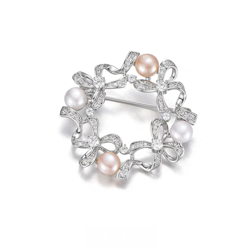 Pearl Bow Wreath Brooch — angled product view on white showing design and scale