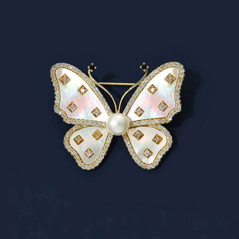 White Mother-of-Pearl Butterfly Brooch with Pearl — front product view on a dark background