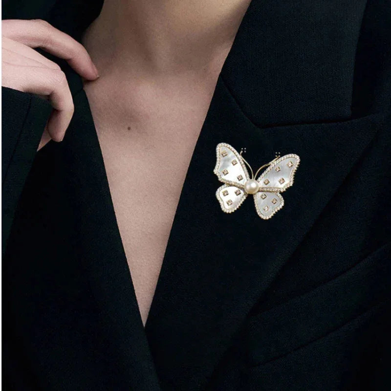 White Mother-of-Pearl Butterfly Brooch with Pearl — alternate black-blazer worn view