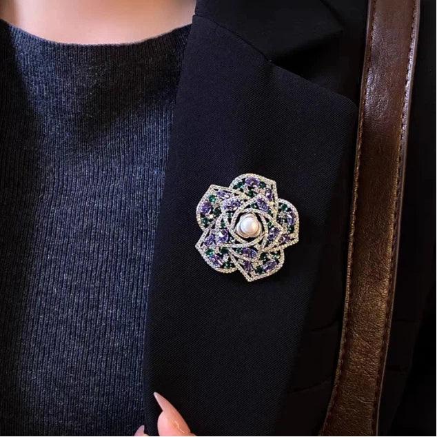 Pearl Purple and Green Camellia Brooch — brooch worn on dark textured fabric