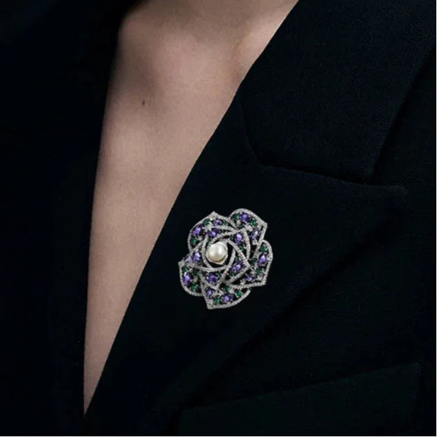 Pearl Purple and Green Camellia Brooch — close black-blazer worn view showing scale