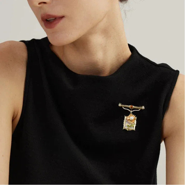 Pearl Sunflower Frame Brooch — brooch worn on a black sleeveless neckline