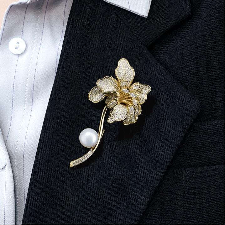 Freshwater Pearl Iris Flower Brooch — close blazer-worn view showing the pearl beside the stem