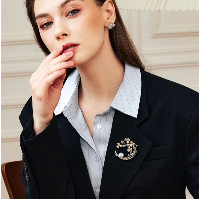 Freshwater Pearl Crescent Floral Brooch — model portrait with the brooch pinned on a dark blazer
