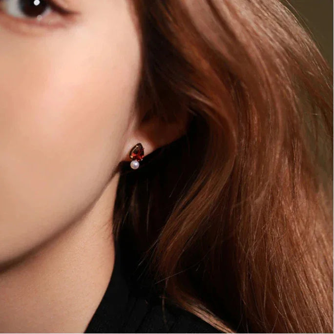 Garnet and Pearl Teardrop Earrings worn on the hand from a second angle