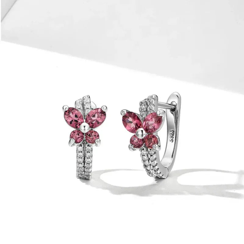 Garnet Butterfly Huggie Hoop Earrings angled product detail on a jewelry display