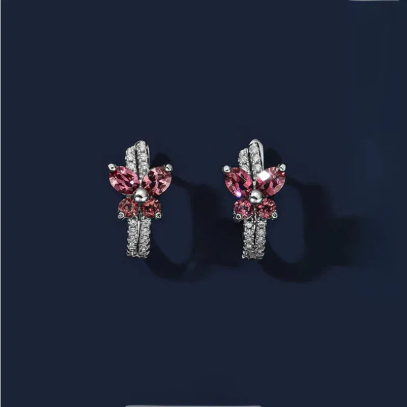 Garnet Butterfly Huggie Hoop Earrings side view held between the fingers