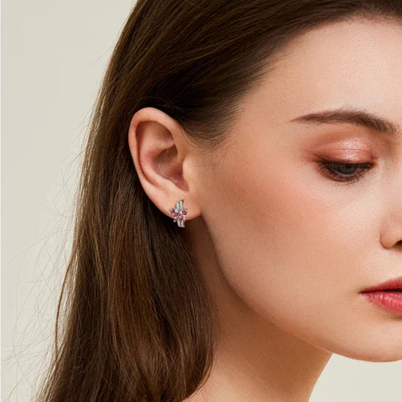 Garnet Butterfly Huggie Hoop Earrings worn on the hand from a second angle