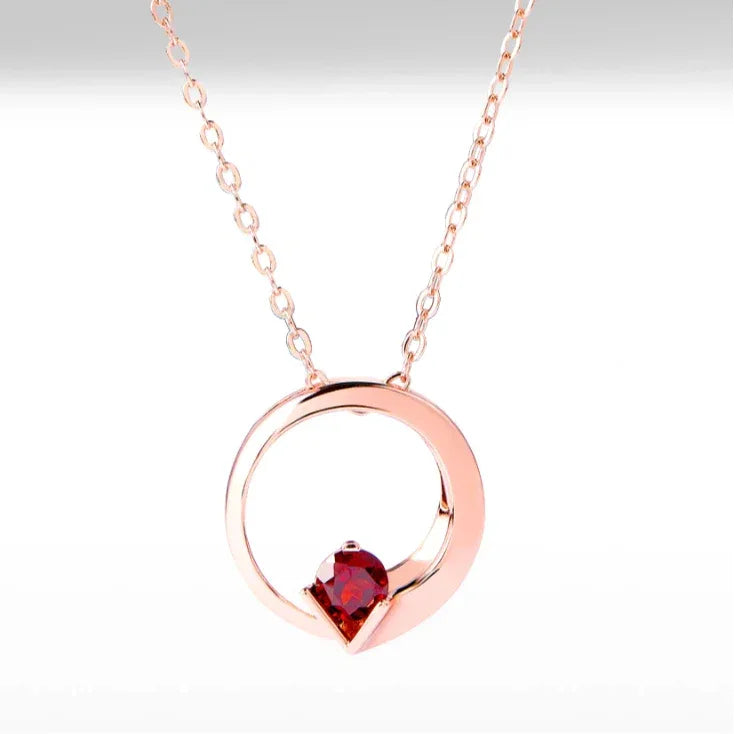 Garnet Circular Pendant Necklace pendant styled on a jewelry display