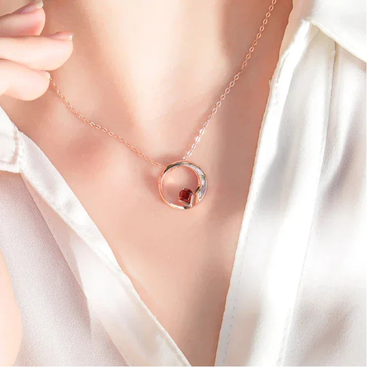 Garnet Circular Pendant Necklace worn at the neckline from a second angle