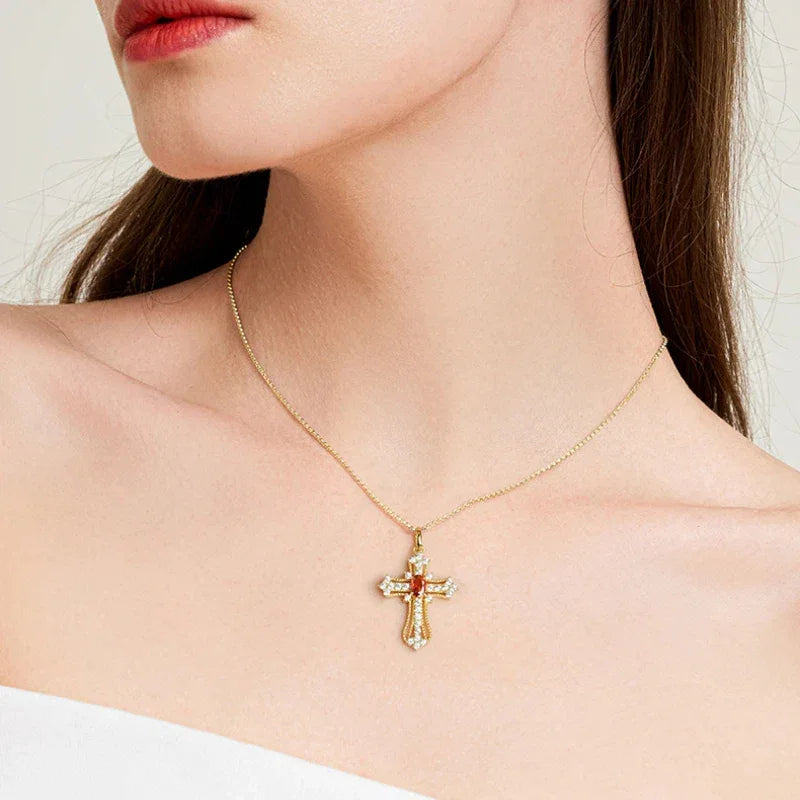 Garnet Cross Pendant Necklace pendant styled on a jewelry display