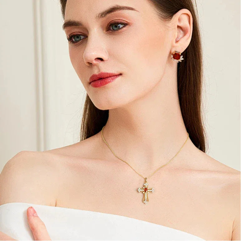 Garnet Cross Pendant Necklace worn at the neckline in a close-up