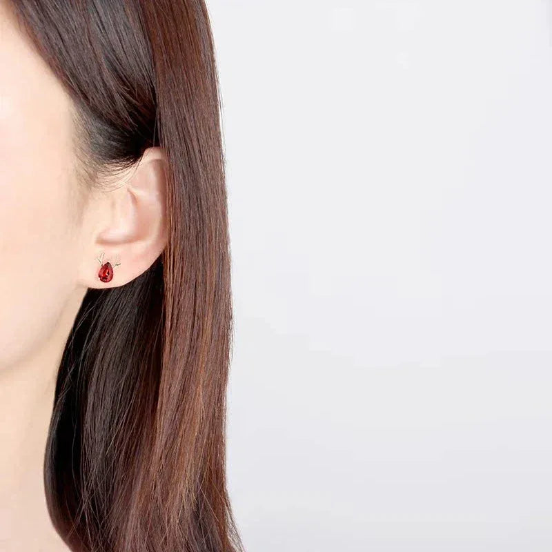 Garnet Deer Stud Earrings worn on the hand from a second angle